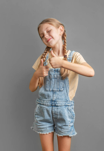 A little blonde  girl shows the ok sign with her hand - Photo, Image
