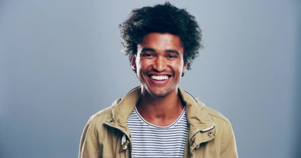 Man, face and laughing for funny joke in studio grey background for humor, comedy or good mood. Male person, model and smile portrait or happy for goofy feeling, joyful silly emoji or mockup space. - Footage, Video