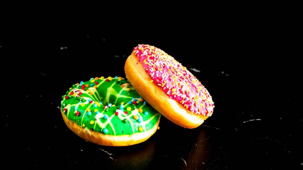 Glazed donuts with sprinkles isolated. Close up of colorful donuts. - Photo, Image
