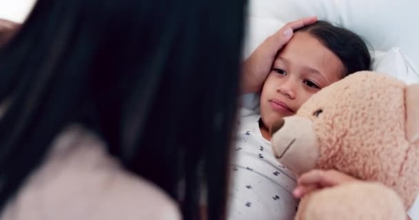 Woman, sick child in bed with comfort for cold or homecare with teddy bear, mother and kid. Illness, fever and young girl in bedroom with mom for healthcare, support and checking temperature in house. - Footage, Video