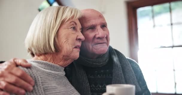 Kiss, elderly couple and coffee in home, love and bonding together in morning in winter. Conversation, senior man and woman with tea cup, drink and healthy relationship, connection or hug for romance. - Footage, Video