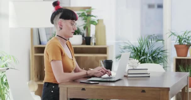 Businesswoman, phone call and laptop in modern office, job and talking of project in digital marketing. Young woman, creative and typing on computer, technology and smartphone for connection at work. - Footage, Video