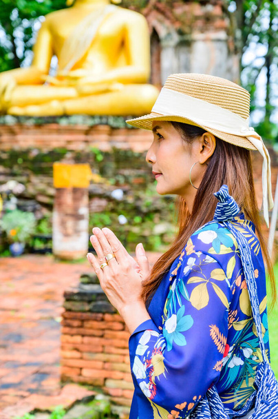 A Woman Traveler with Wat Phra That Song Pee Nong Background at Chiang Saen District, Chiang Rai Province. - Fotó, kép