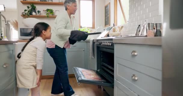 Kitchen, oven and grandmother cooking with child learning to prepare dinner, supper or lunch in a home. Grandchild, support and grandma baking with kid or girl and happy for a fresh meal together. - Footage, Video