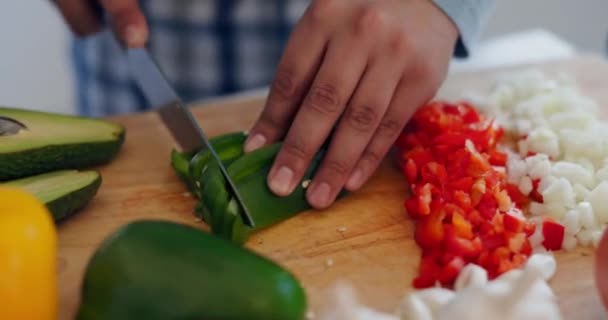 Koken, gezond eten en handen met mes in een keuken met groenten, avocado en gezondheid maaltijd prep. Persoon, dieet en lunch in een huis met salade, houtsnijplank en hak voor het diner in een huis. - Video