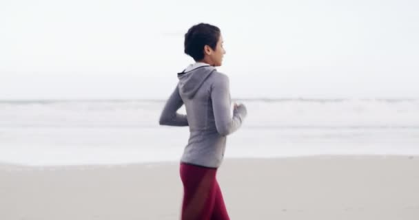 Спорт, здоров'я і жінка, що бігає на пляжі для гонки, змагань або марафонських тренувань. Фітнес, розігрів і молода жінка спортсменка біжить з кардіо вправами або фізичними вправами на піску океаном або морем - Кадри, відео