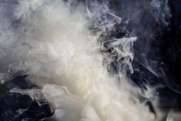 Gray and white smoke in sunlight on a black background - Photo, Image