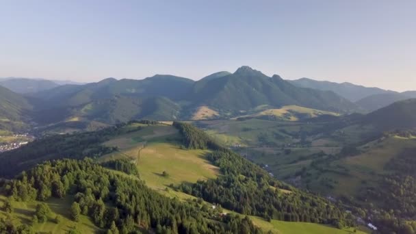 Літати над зеленою сільською місцевістю в альпійському гірському пейзажі на літньому заході сонця. Вид з повітря, літати вперед.  - Кадри, відео