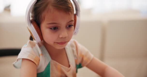 Headphones, online learning and child writing in book, studying and homework for homeschool. Virtual classroom, remote education and kid or student with digital technology for knowledge on video call. - Footage, Video