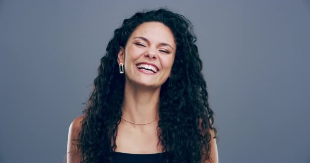 Face, funny or happy woman laughing in studio at joke or crazy comedy isolated on gray background. Girl hipster, cool lady or silly female person with pride, smile or goofy joy to relax with humor. - Footage, Video