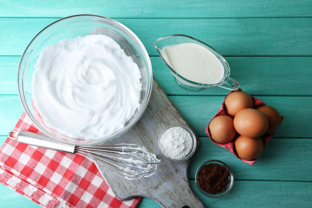 Whipped egg whites for cream on wooden table, top view - 写真・画像