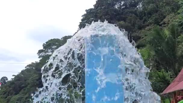 an overflowing fountain at the site of a public swimming pool near a highway - Footage, Video