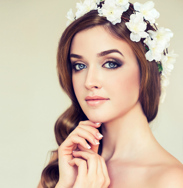 Woman with decorative flowers in hair - Foto, imagen