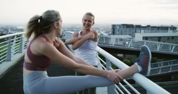 Woman, stretching or runners on bridge with talking, strong or fitness collaboration in city in training. Young people, friends or conversation in exercise, bonding or cardio workout in urban outdoor. - Footage, Video