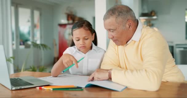 Girl kid, grandfather and book for education, focus and studying for development in home school. Child student, senior man and point at notebook with mindset, writing and help for assessment at desk. - Footage, Video