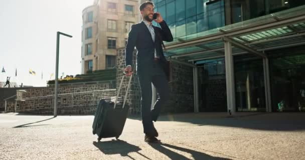 Business man, suitcase and phone call in city for professional communication, transport and travel news or information. Happy corporate worker with mobile chat, luggage and walking outdoor to airport. - Footage, Video