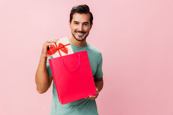 Man package buy surprise fashion pink gift bag happy holiday sale purchase background women present shop day store lifestyle discount client shopper isolated - Photo, Image