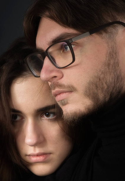 Portrait of a young couple on a black background. - Photo, Image