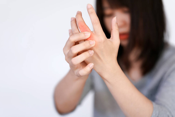 Woman has finger joint pain due to rheumatoid arthritis. Health care concept. - Photo, Image