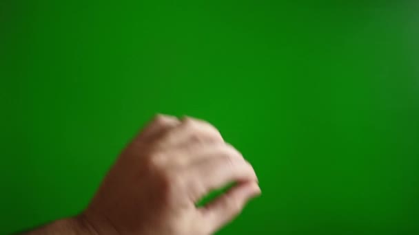 Una mano masculina en una pantalla verde hace un gesto para agrandar la imagen. Concepto pantalla táctil. - Metraje, vídeo