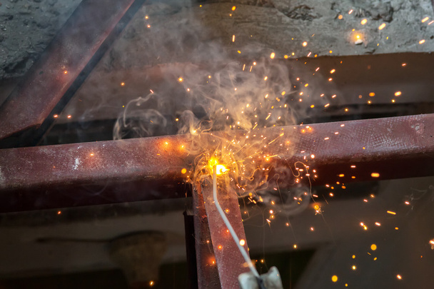 welding steel with spread spark lighting smoke - Photo, Image