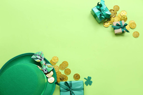 Leprechaun hat with bow tie, gifts and golden coins on light green background. St. Patrick's Day celebration - Foto, afbeelding