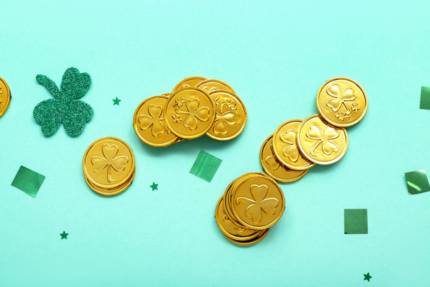 Golden coins with sequins on blue background. St. Patrick's Day celebration - Фото, изображение