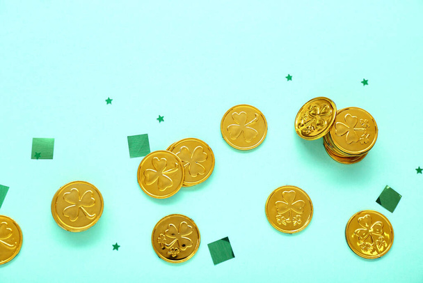 Golden coins with sequins on blue background. St. Patrick's Day celebration - Φωτογραφία, εικόνα