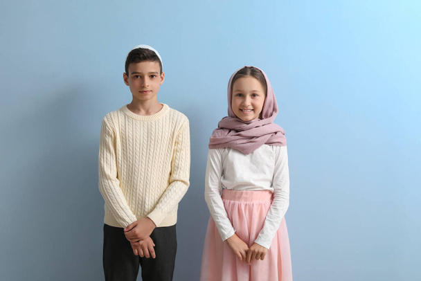 Little Muslim children on light blue background - Zdjęcie, obraz
