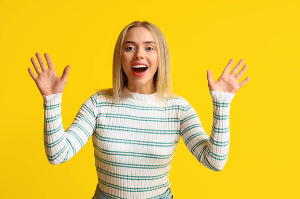 Happy young woman on yellow background - Photo, Image