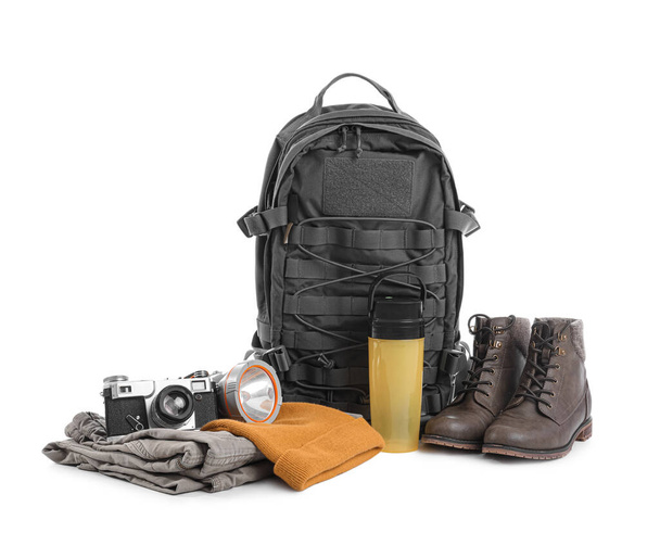 Set of camping equipment with backpack, photo camera and thermal bottle on white background - Zdjęcie, obraz