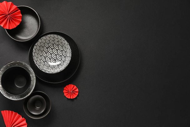 Bowl with decor on black background. Chinese table setting - Φωτογραφία, εικόνα