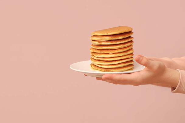Little girl with tasty pancakes on beige background - Φωτογραφία, εικόνα