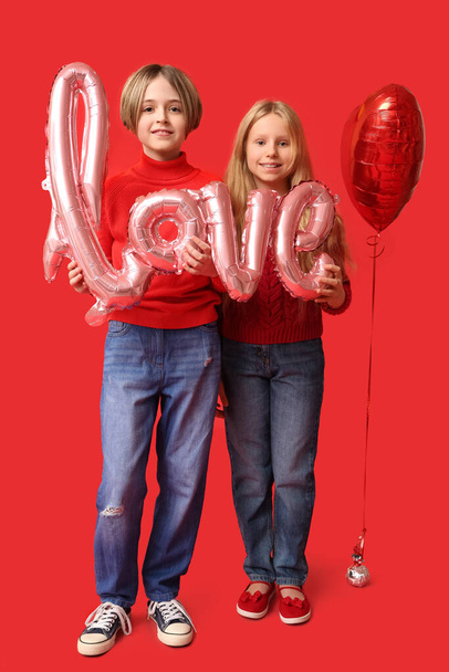 Little children with word LOVE and balloon on red background. Valentine's Day celebration - Φωτογραφία, εικόνα
