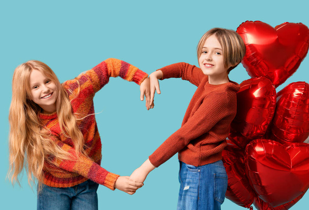 Little children with balloons making heart gesture on blue background. Valentine's Day celebration - Photo, Image