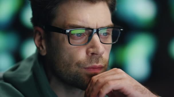 Man programer looking computer making system research at workplace closeup. Serious specialist administrator in glasses staring monitor analysing big data AI. Guy reading coding language interface - Footage, Video