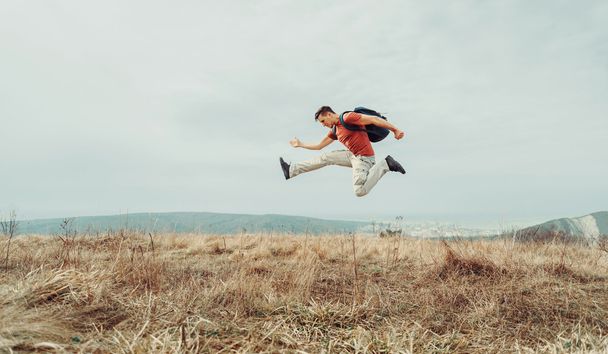 Hiker man jumping on nature - 写真・画像