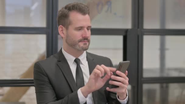 Portrait of Middle Aged Businessman Celebrating Success on Phone - Footage, Video