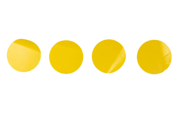 Adesivi gialli rotondi, etichette vuote isolate su uno sfondo bianco. Vista dall'alto.  - Foto, immagini