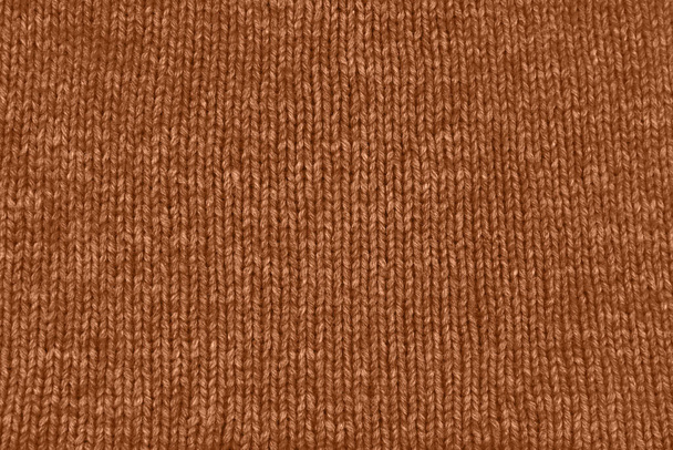 Фон текстильной ткани с текстурой вязаной шерсти в персиковом цвете. Цвет года 2024 Персиковый пух - Фото, изображение