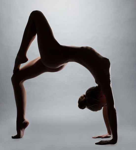 Flexible naked girl doing fitness exercise - Foto, imagen