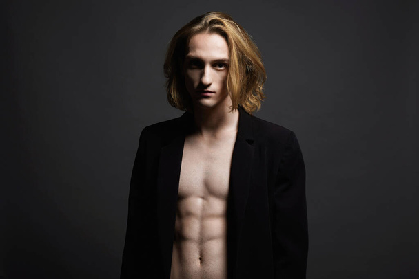 Sexy Boy with long hair. handsome young Man with trendy Hairstyle. Studio Portrait - Photo, Image