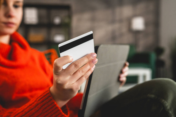 Close up on hand of unknown woman hold credit card shopping online - Foto, imagen