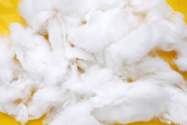 Polyester stable fiber on yellow background. - Photo, Image