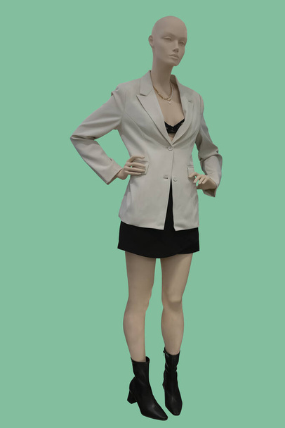 Imagen completa de un maniquí femenino con ropa de moda aislada sobre fondo verde - Foto, imagen