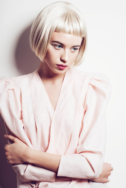 Portrait of a beautiful young blond woman with short hair in the studio on a white background - Foto, Imagem