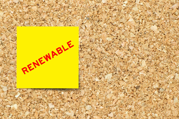 Yellow note paper with word renewable on cork board background with copy space - Photo, Image