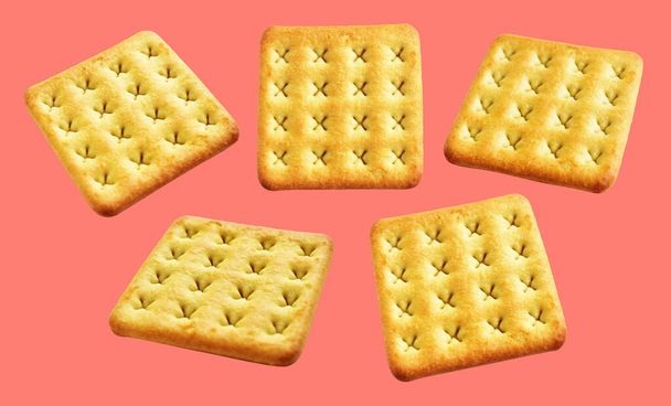 Square crackers isolated or biscuits, butter cookies with clipping path, no shadow in pink background - Foto, Imagen
