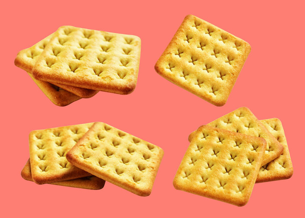 Square crackers isolated or biscuits, butter cookies with clipping path, no shadow in pink background - 写真・画像