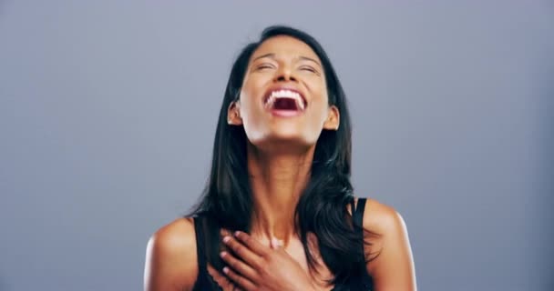 Funny, face and black woman in studio laugh with happiness, freedom or reaction to joke. Happy, portrait and girl with comedy, comic or lol emoji with humor and smile in grey background or mockup. - Footage, Video